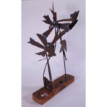 AN ABSTRACT MID-CENTURY SCULPTURE COMPRISED OF COOPER FLOWERS ON DRIFTWOOD BASE