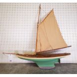 AN EARLY 20TH CENTURY PAINTED MODEL OF A POND YACHT