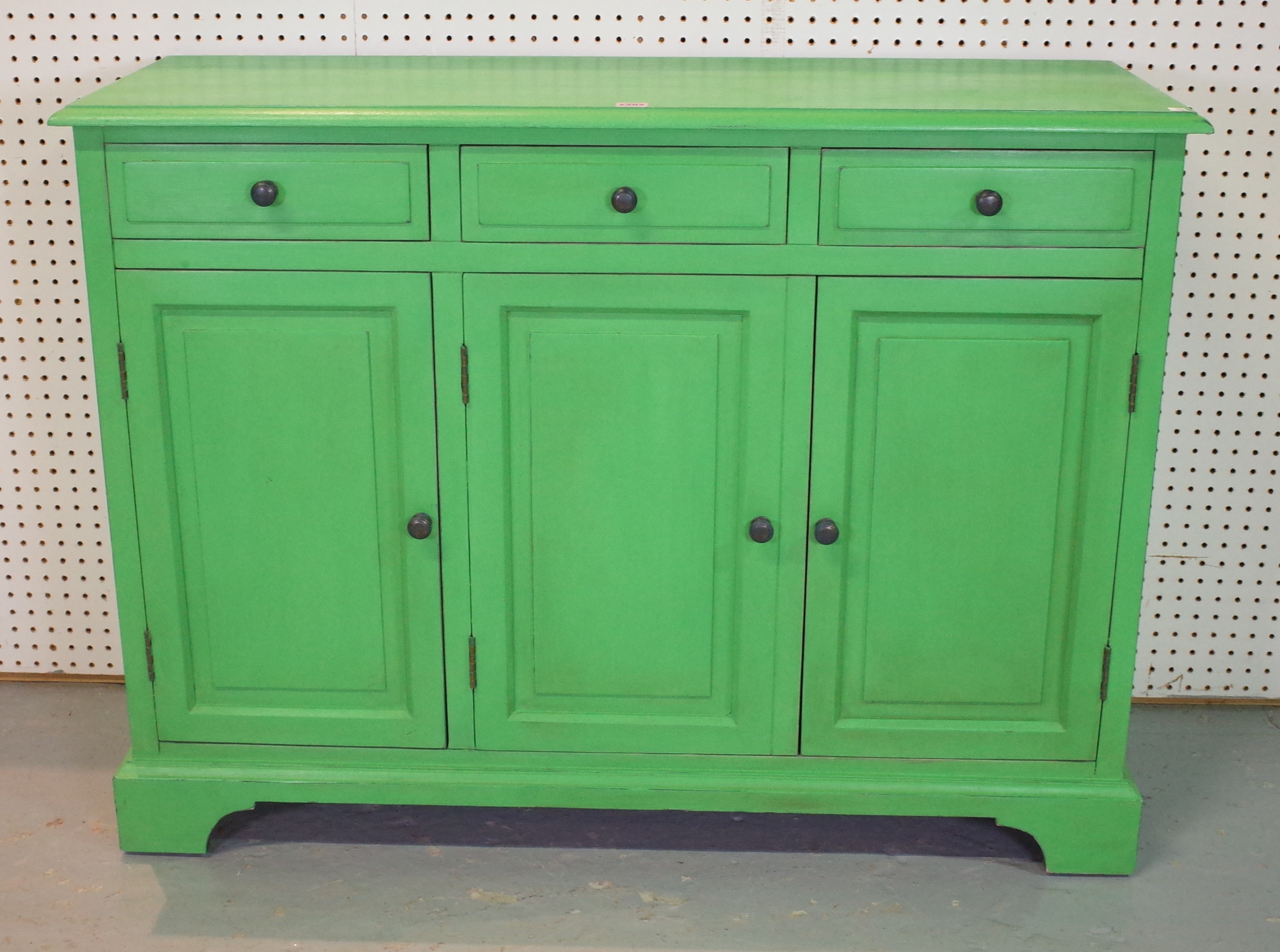 A MODERN GREEN PAINTED SIDE CABINET WITH THREE DRAWERS AND THREE CUPBOARDS