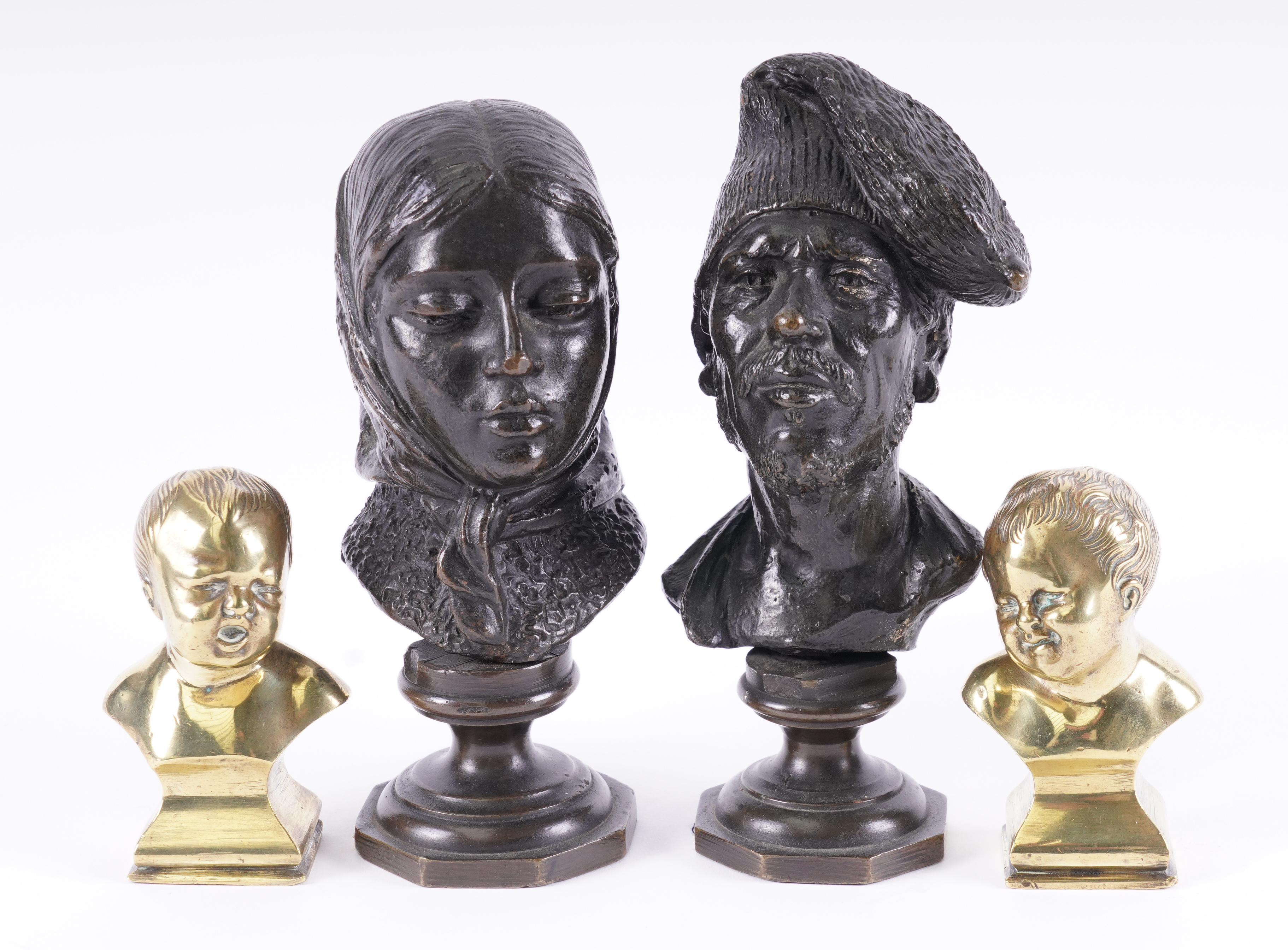 TWO FRENCH BRONZE PORTRAIT BUSTS OF WOMAN IN A HEADSCARF AND A BEARDED MAN WEARING A CAP OF...