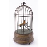 A SINGING BIRD AUTOMATON IN BRASS CAGE