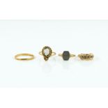 A 22CT GOLD BAND AND THREE FURTHER RINGS (4)