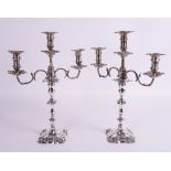 A PAIR OF SILVER TABLE CANDLESTICKS WITH ASSOCIATED SILVER THREE LIGHT CANDELABRA BRANCHES