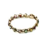 A GOLD AND VARICOLOURED GEMSTONE BRACELET