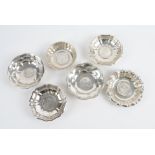 SIX FOREIGN AND PLATED DISHES MOUNTED WITH COINS (6)
