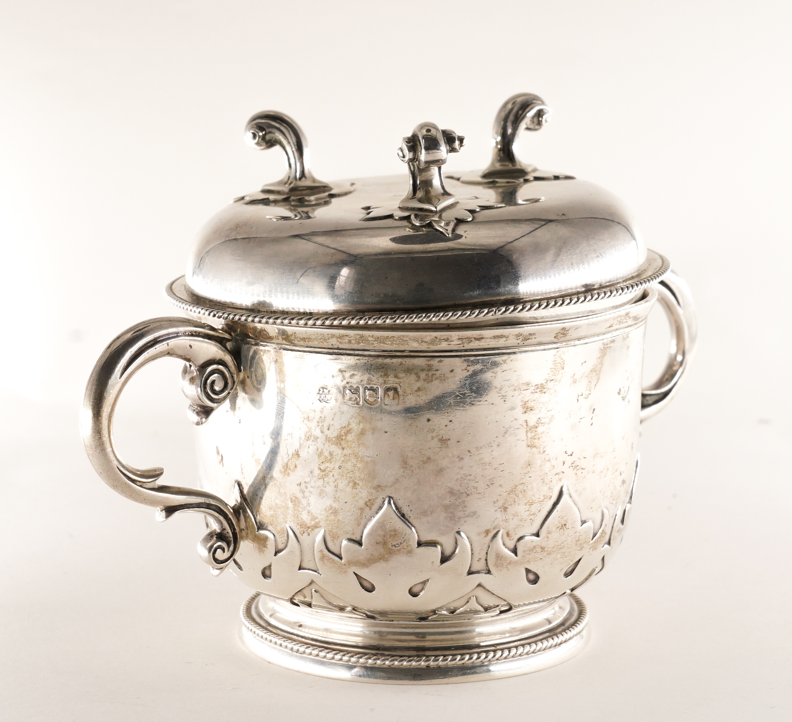 A SILVER TWIN HANDLED CUP AND COVER