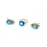 A GOLD AND TREATED BLUE TOPAZ SOLITAIRE RING AND A PAIR OF TREATED BLUE TOPAZ AND DIAMOND...