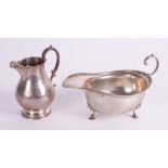 A SILVER CREAM JUG AND A SILVER SAUCEBOAT (2)