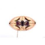 A VICTORIAN GOLD AND GARNET THREE STONE BROOCH