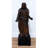 A NORTH EUROPEAN CARVED WALNUT FIGURE OF A WOMAN IN A HEADDRESS