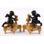 A PAIR OF LOUIS XVI STYLE BRONZE MOUNTED GILT-METAL CHENETS (2)