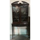 A 19TH CENTURY MAHOGANY DISPLAY CABINET ON STAND