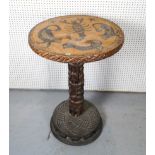 A TRIBAL HARDWOOD CIRCULAR OCCASIONAL TABLE