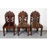 A MATCHED SET OF THREE TRIBAL STYLE HARDWOOD DINING CHAIRS (3)