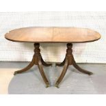 A REGENCY STYLE MAHOGANY D-END EXTENDING DINING TABLE
