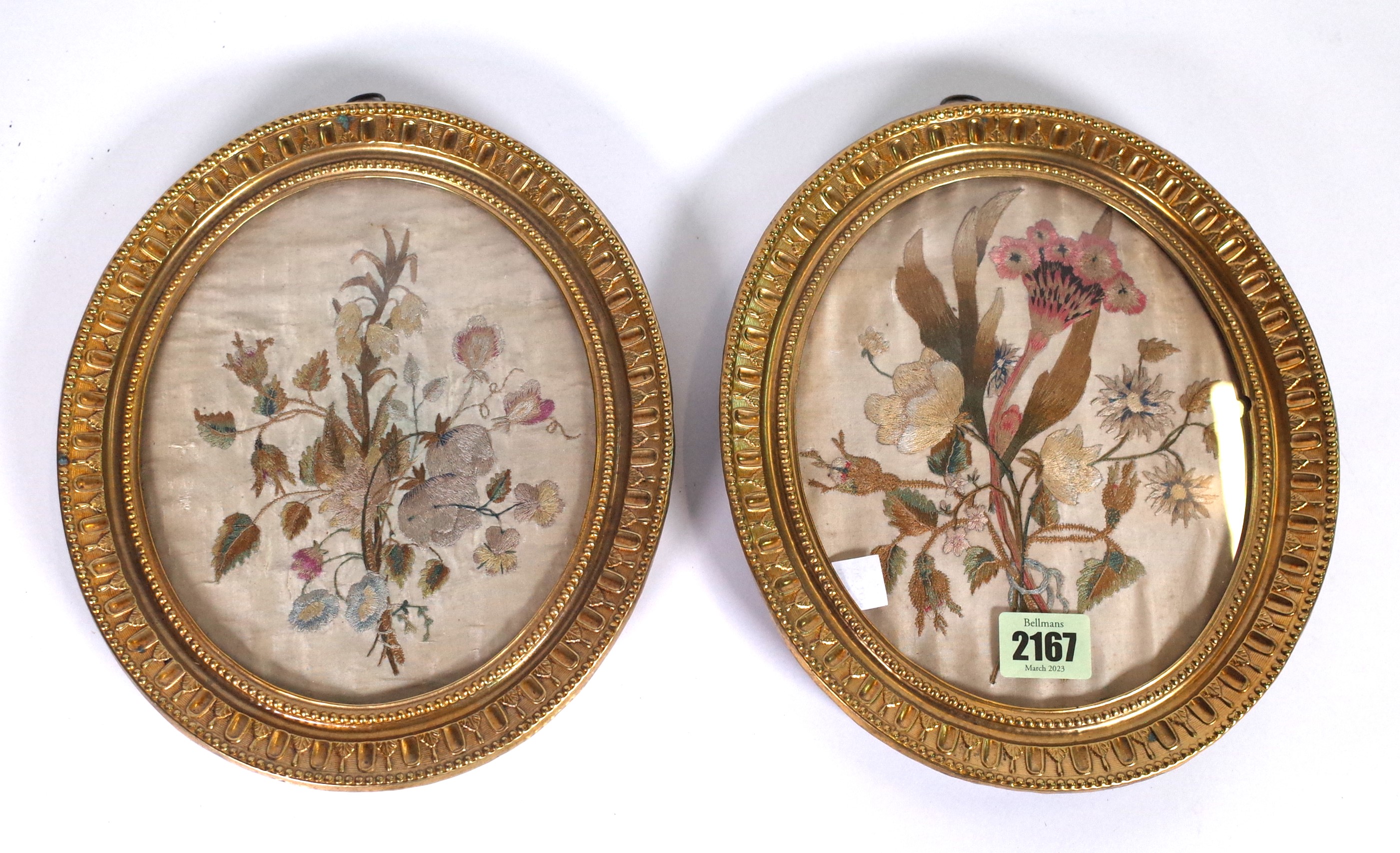 A PAIR OF 19TH CENTURY OVAL SILKWORK EMBROIDERED FLORAL PANELS