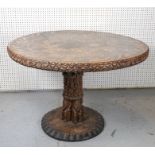 A TRIBAL STYLE HARDWOOD CIRCULAR CENTRE TABLE