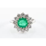 AN EMERALD AND DIAMOND CLUSTER RING