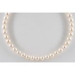 A SINGLE STRAND CULTURED PEARL NECKLACE WITH A DIAMOND SET CLASP