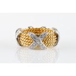 A DIAMOND AND GOLD CROSS OVER RING