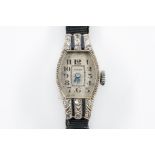 AN ESZEHA LADY'S WHITE GOLD, DIAMOND AND BLUE GEM SET DRESS WRISTWATCH