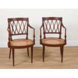 A PAIR OF POLYCHROME PAINTED SATINWOOD LATTICE BACK OPEN ARMCHAIRS ON TURNED SUPPORTS (2)