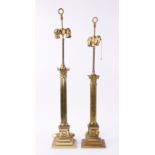 A GRADUATED PAIR OF GILT-METAL CORINTHIAN COLUMN TABLE LAMPS (2)