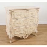 A CREAM PAINTED ROCOCO REVIVAL SERPENTINE THREE DRAWER CHEST