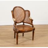 A CHILD’S CARVED MAHOGANY FRAMED CANE BACK ARMCHAIR OF LOUIS XVI DESIGN