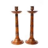 A PAIR OF ARTS AND CRAFTS COPPER AND FRUITWOOD CANDLESTICKS (2)