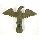 A 19TH CENTURY CARVED WOOD FIGURE OF A BASKING EAGLE