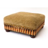 A FOOT STOOL WITH WOOL EMBROIDERED TASSELS