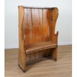 A 19TH CENTURY PINE HIGH WINGBACK CONCAVE SETTLE