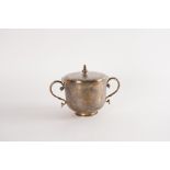 A SILVER TWIN HANDLED CUP AND COVER