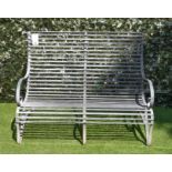 A REGENCY STYLE STRAP METAL GARDEN BENCH