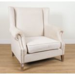 A LARGE MODERN WINGBACK ARMCHAIR