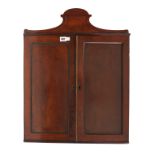 A REGENCY MAHOGANY TWO DOOR HANGING CUPBOARD WITH FITTED INTERIOR