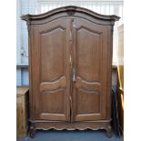 AN 18TH CENTURY FRECH OAK BONNET TOPPED TWO DOOR ARMOIRE