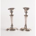 A PAIR OF LATE VICTORIAN SILVER CANDLESTICKS