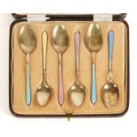 A SET OF SIX SILVER GILT AND VARICOLOURED ENAMEL COFFEE SPOONS