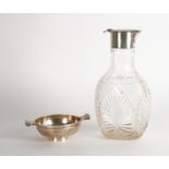 A SILVER TWIN HANDLED BOWL AND A SILVER MOUNTED FACETED GLASS CLARET JUG (2)