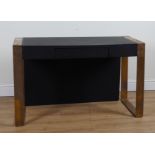 ‘DAVIDSON LONDON’ A LEATHER UPHOLSTERED WRITING DESK ON BRONZE SUPPORTS