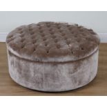 A VELVET UPHOLSTERED CIRCULAR FOOTSTOOL