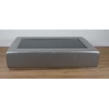 A SILVER COLOURED LEATHER UPHOLSTERED RECTANGULAR COFFEE TABLE