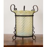 AN ARTS & CRAFTS WROUGHT-IRON LANTERN WITH SHAPED VASELINE GLASS SHADE