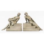 A PAIR OF LEAD ALLOY RECLINING FIGURE BOOKENDS (2)