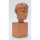 A TERRACOTTA PAINTED PLASTER BUST OF A YOUNG BOY INSCRIBED ‘FRANZ STUCK 1890’