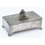 SVENSKT TENN: A SWEDISH PEWTER CIGARETTE OR JEWELLERY BOX MOUNTED WITH A SEATED FIGURE OF PAN