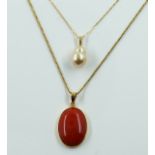 A GOLD AND CORAL PENDANT WITH A GOLD NECKCHAIN AND A GOLD AND FRESHWATER PEARL EPDNANT WITH A...