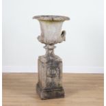 A LATE 19TH CENTURY COMPOSITION STONE URN ON PEDESTAL